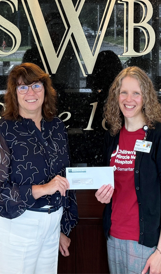 A photo of a WSB donation to CMN of Watertown.