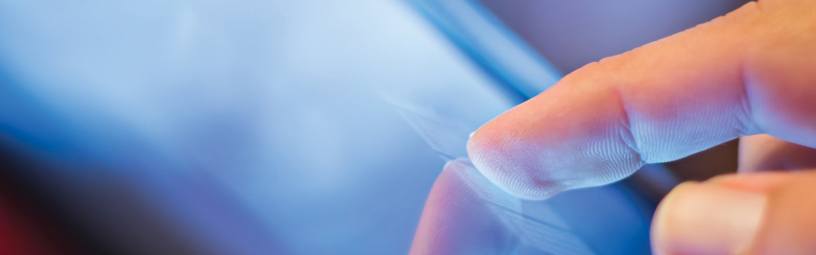 A human finger touching a computer screen.
