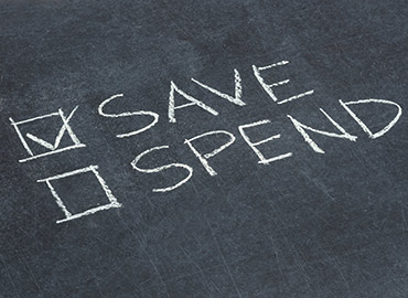 Save vs Spend, save checked, written on chalkboard.
