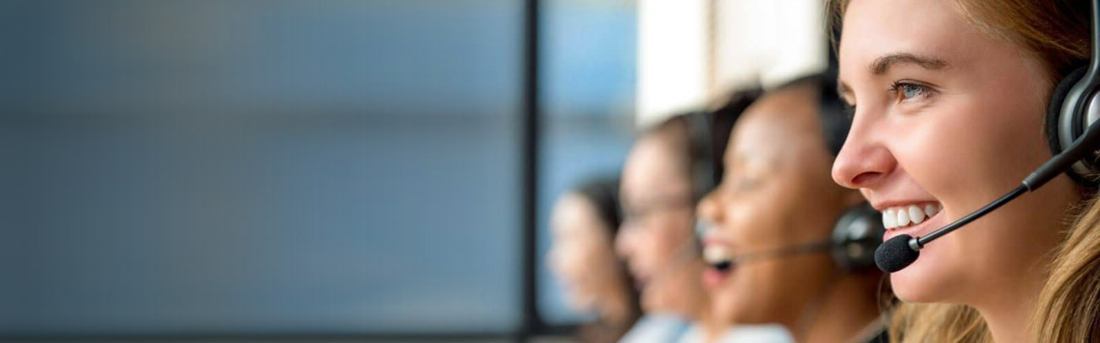 A group of female phone attendants wearing headset devices.