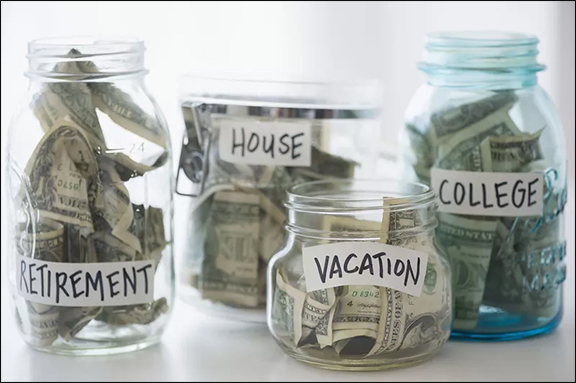 Clear glass jars filled with cash labeled "Retirement", "House", "Vacation" and "College".