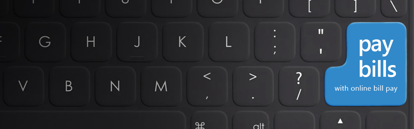 A computer keyboard displaying a large button that says "Pay Bills".
